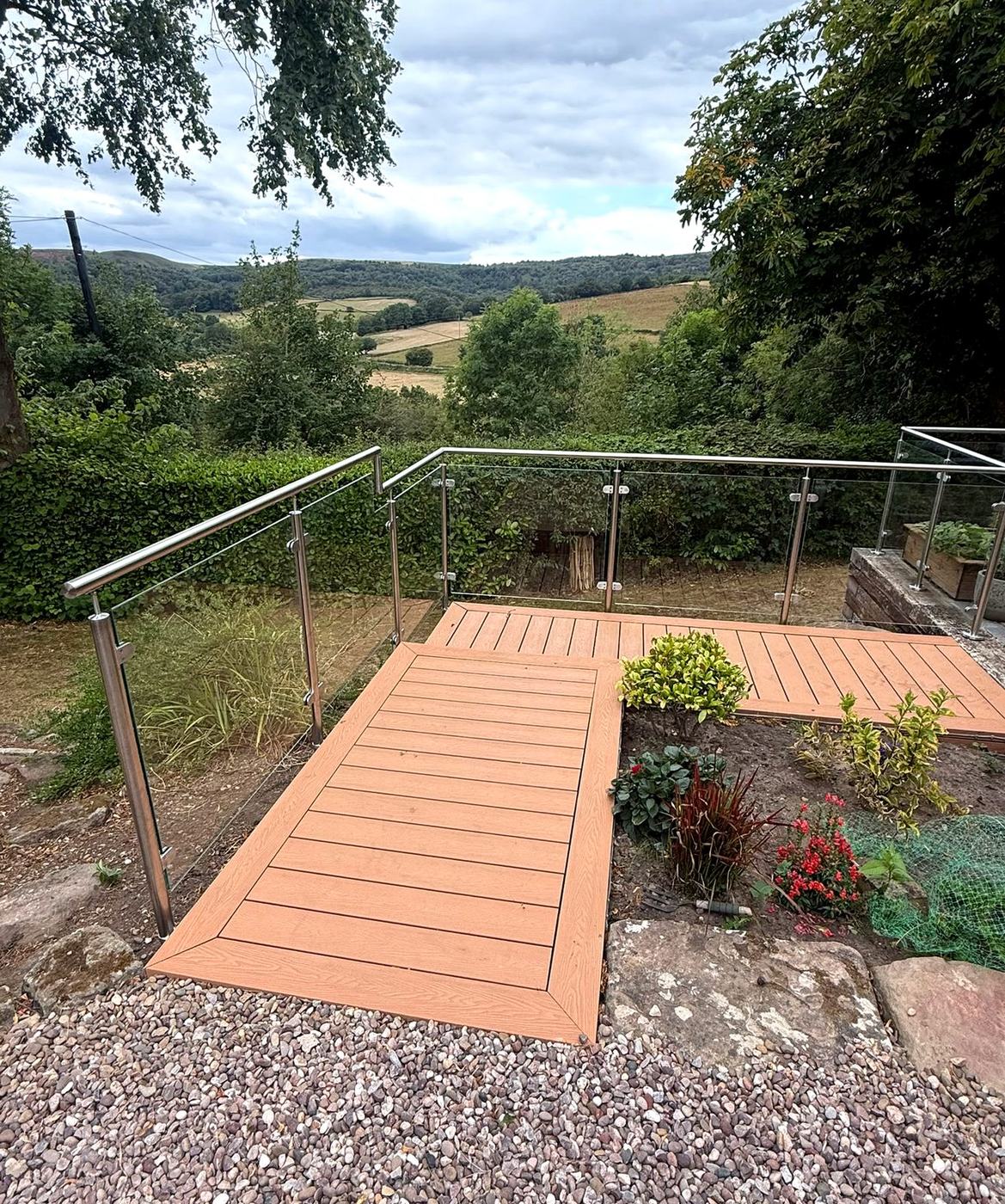 Side-fixed stainless and glass balustrade to a composite deck looking out over open countryside, Sheffield
